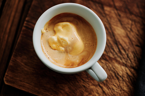 Cup of Espresso Affogato, Vanilla Ice cream in a cold cup with freshly brewed espresso coffee poured over the top.