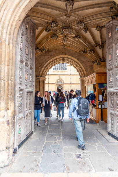 Bodleian Library building entrance Group of tourists in the entrance to the Bodleian Library and All Souls College at the university of Oxford. Oxford, Oxfordshire, England, UK bodleian library stock pictures, royalty-free photos & images