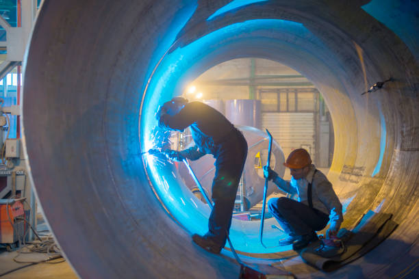 istock Two welders work in a pipe for an oil pipeline. 1226438327