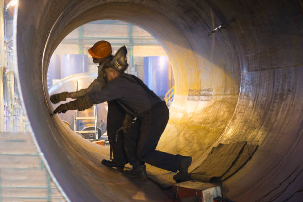 istock Two welders work in a pipe for an oil pipeline. 1226439007
