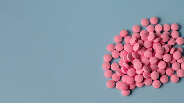 istock pile of pink pills, conceptual image 1226439317