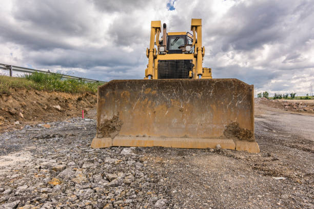 istock Excavator on the road widening works at a construction site 1226440344