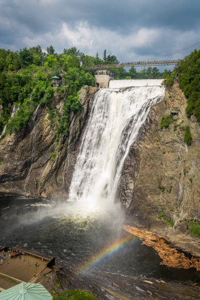 istock Cloudy summer day with insane view of beautiful and powerful Montmorency waterfall with a rainbow in front 1226440607