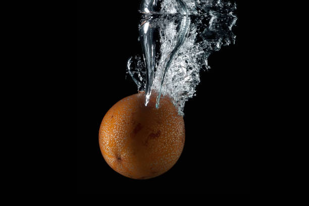 passion fruit entering the water and splashing