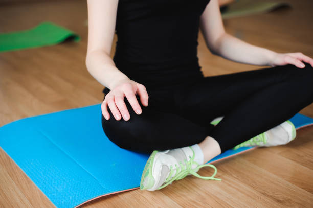 istock athletic woman doing relaxation exercises in gym class 1226444776