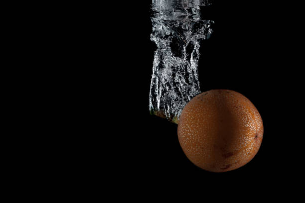 passion fruit entering the water and splashing