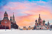View of Kremlin and St. Basil Cathedral at the Red Square during sunset in winter. Famous landmarks in Moscow, Russia