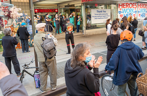 Manhattan, New York, USA - May 21, 2020: Healthcare workers at the Lenox Health Emergency room entrance are greeted to cheers and thanks for their essential service during the covid-19 pandemic in New York city.