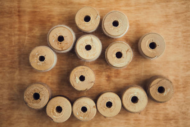 Set of thread on wooden background, flat lay, top view