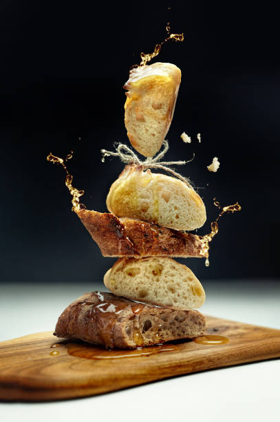 Creative composition of bread, honey on a wooden board