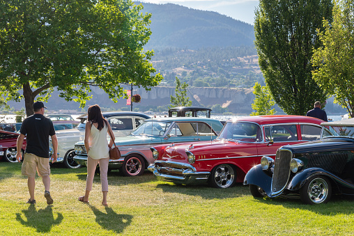Penticton, British Columbia/Canada - June 22, 2019: people viewing vintage cars on display at the Peach City Beach Cruise, a popular annual car show and the largest of it's kind in the Okanagan Valley.