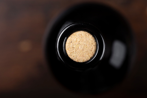 cork in a bottle close-up. closed bottle of wine, top view. place for text