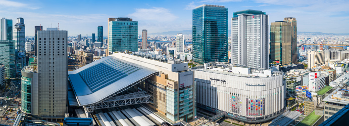Aerial panoramic view across the busy shopping streets of Umeda and the towering skyscrapers of downtown Osaka, Japan’s vibrant second city.