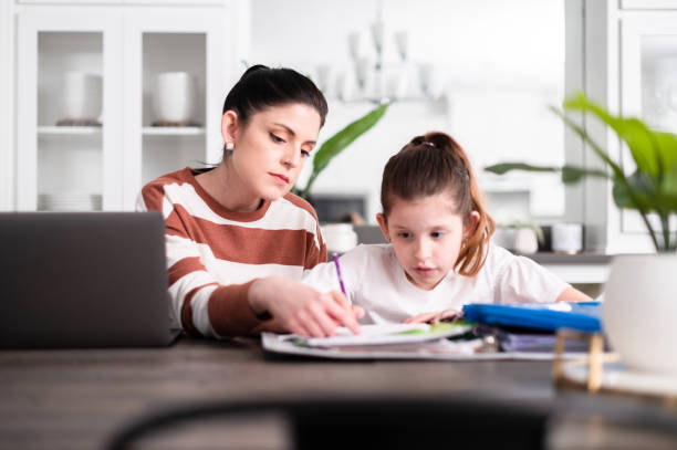 istock Mother points out mistake on schoolwork to daughter 1226458736