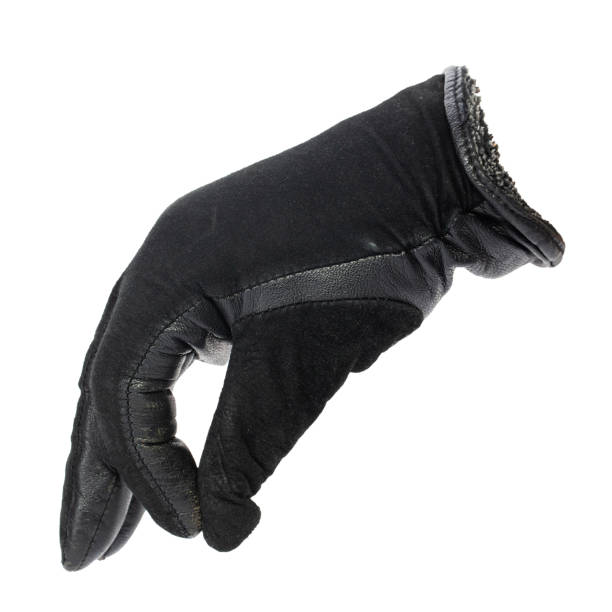 istock a hand in a black leather glove holds something with his fingers. 1226458822