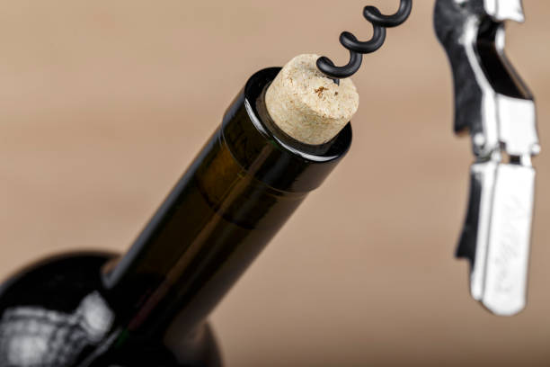 istock bottle of wine with a corkscrew in a cork, closeup. 1226459374
