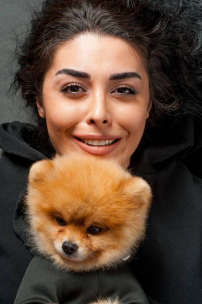 istock Woman keeping pomeranian spitz 1226460931