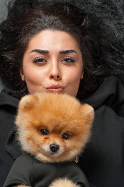istock Woman keeping pomeranian spitz 1226460958