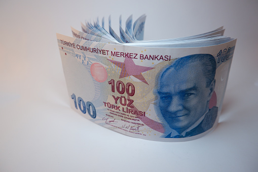 Republic of Turkey one hundred Turkish Lira banknotes isolated on white background. Turkish economy, finance and accounting concept. Close-up with copy space.