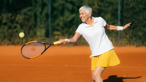 istock Smiling Elderly Woman Playing Tennis as a Recreational Activity 1226463390