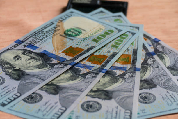 istock U.S. dollars by 100 fan and calculator on table 1226463577
