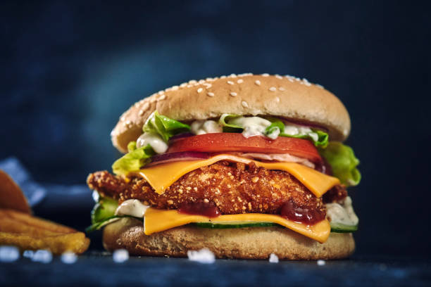 istock Crispy Chicken Burger with Cheese, Tomato, Onions and Lettuce 1226464409