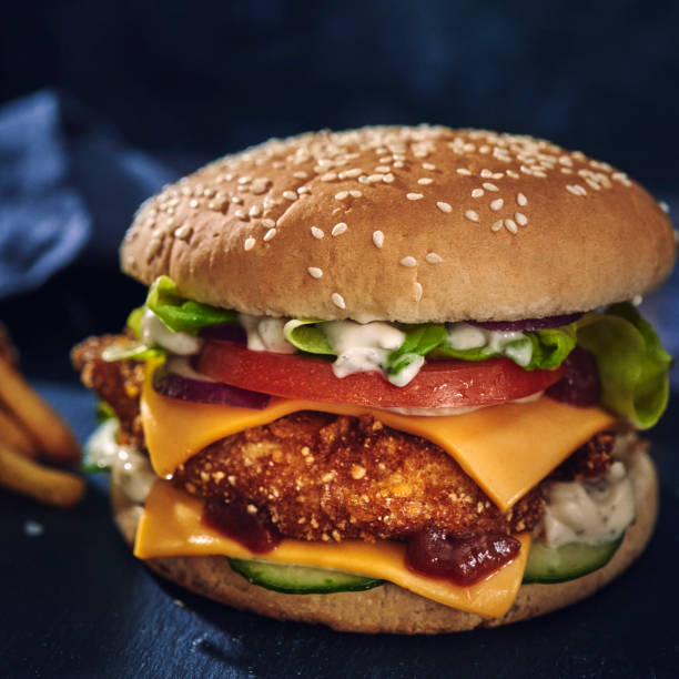 istock Crispy Chicken Burger with Cheese, Tomato, Onions and Lettuce 1226464444