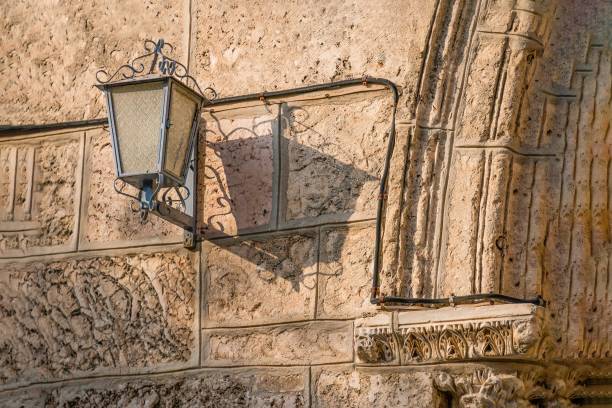 istock Vintage lantern and its shadow on an old wall 1226464673