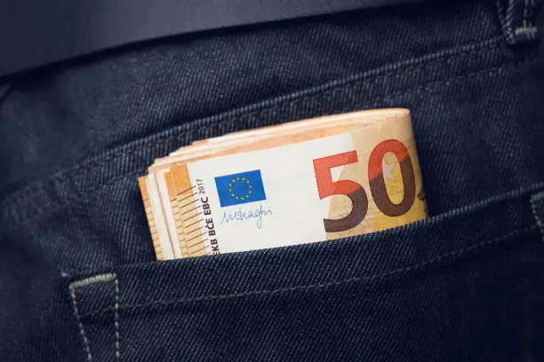 Pack of 50 euros in a jeans pocket close-up.