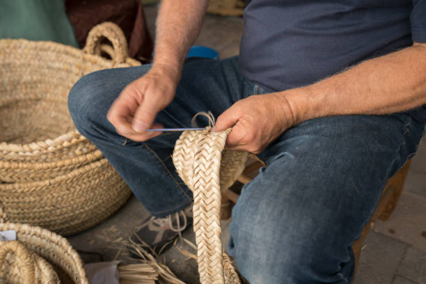 wicker basket hand man weaving a wicker basket basket weaving stock pictures, royalty-free photos & images