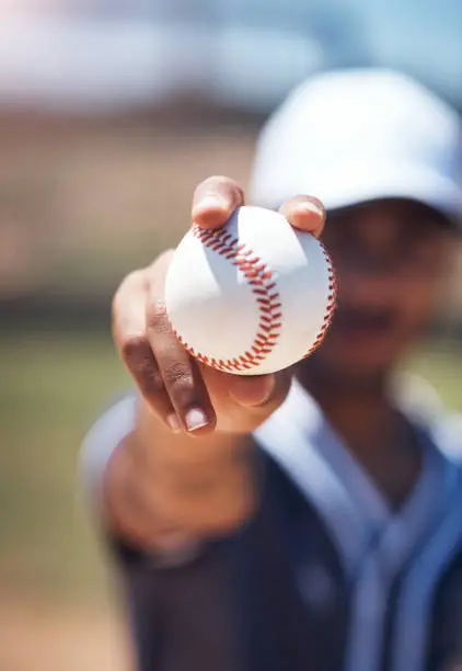 Shot of a man holding a ball during a baseball match