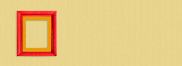 istock Red wooden frame on  bright yellow background. 1226466952