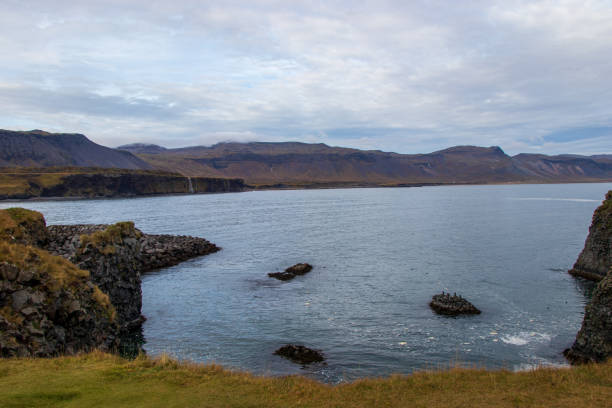 istock rough landscape with mountains, sea and waterfalls 1226467681