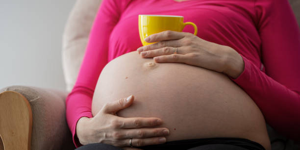 istock Pregnant belly with tea cup on it 1226467876