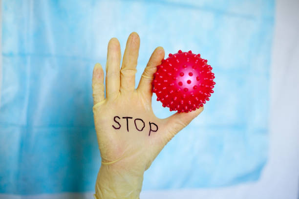 istock Stop Covid-19. Text on medical glove. 1226469325