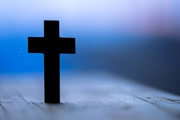 istock cross in wooden background 1226469329