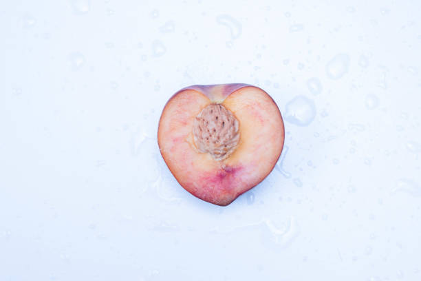 cut peach in half lies on a table