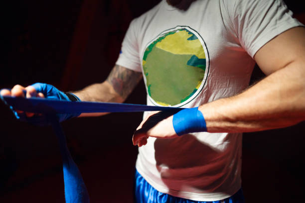 istock Boxer wraps his fists in bandages 1226470210