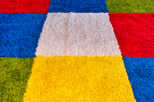 Carpet with various colors and squares bright colors modern design close-up
