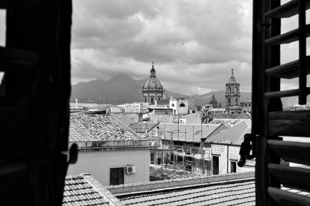 The old town of Palermo through the open window with shutters, Sicily, Italy. Balck and white cityscape