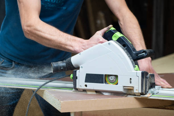 istock Carpenter using a disk saw to cut wooden boards. Constructive details of a male worker or a comfortable man with power tools 1226473528