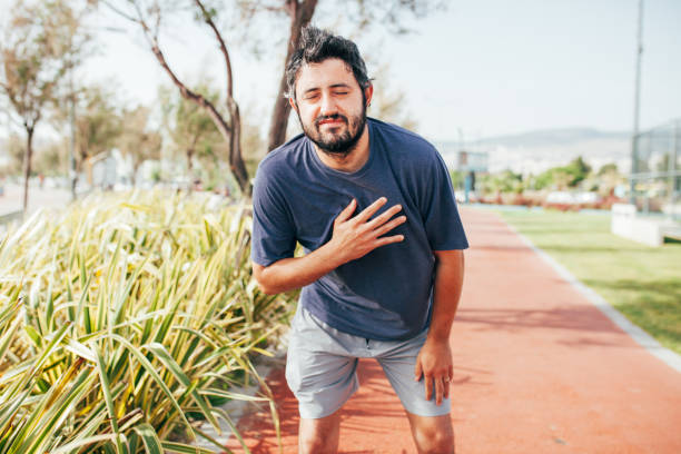 istock Man suffering from chest pain at park 1226477936