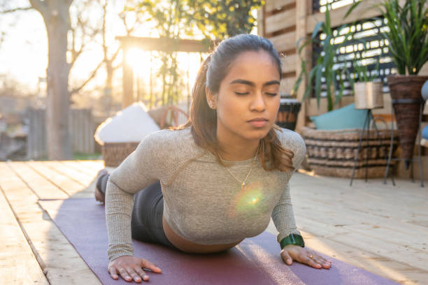istock Southeast Asian female doing yoga on her deck during sunset 1226478132