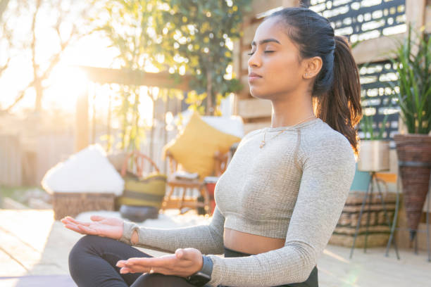 istock Southeast Asian female doing yoga on her deck during sunset 1226478135