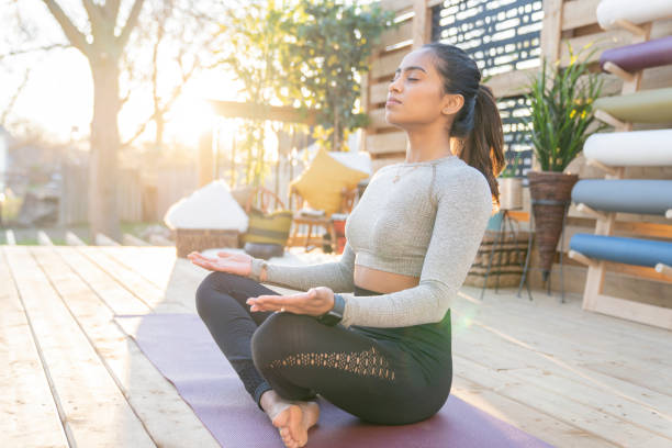 istock Southeast Asian female doing yoga on her deck during sunset 1226478143