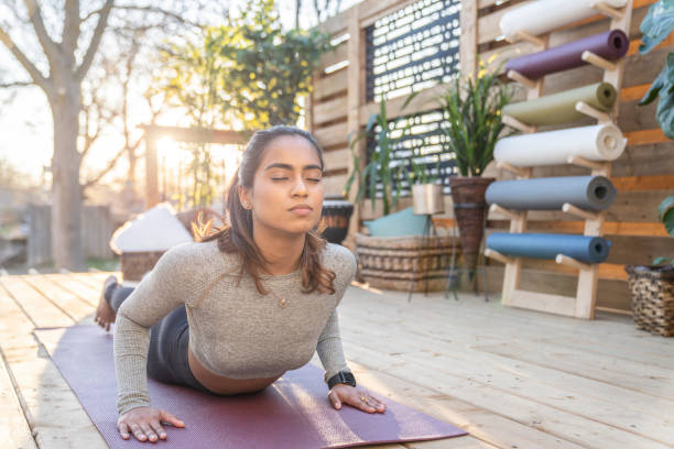 istock Southeast Asian female doing yoga on her deck during sunset 1226478148