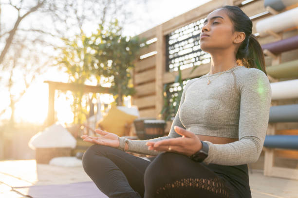 istock Southeast Asian female doing yoga on her deck during sunset 1226478150