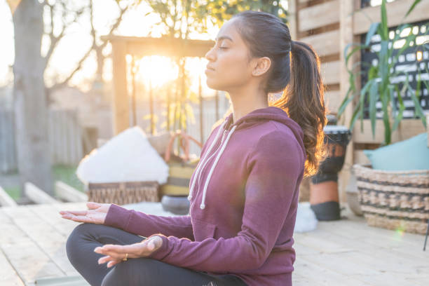 istock Southeast Asian female doing yoga on her deck during sunset 1226478156