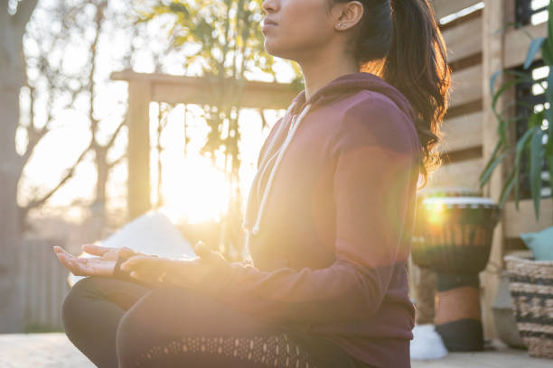 istock Southeast Asian female doing yoga on her deck during sunset 1226478505