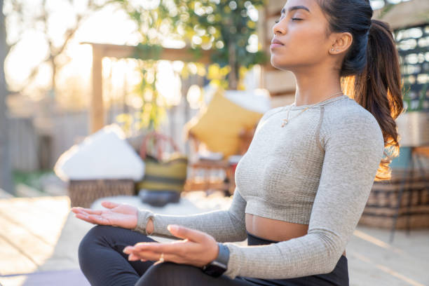 istock Southeast Asian female doing yoga on her deck during sunset 1226478647